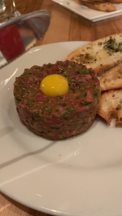 Le Comptoir - Breaking the quail egg yolk on the Beef Tartar. - French Near Me - San Rafael, California