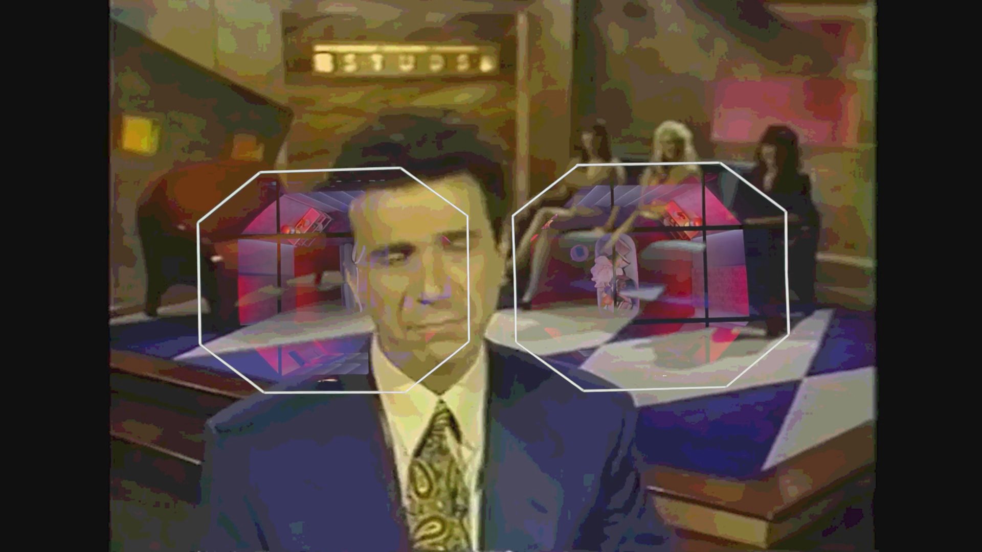 The host of the dating game show Studs addresses the audience from the program's studio set before the show's title graphic appears on screen.