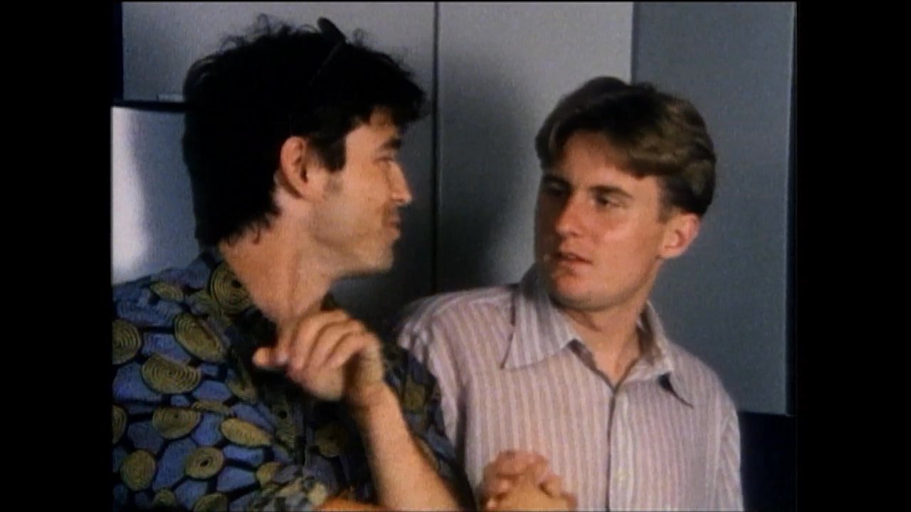 Two men engage in a professional conversation, concluding their discussion with a firm handshake and verbal exchange in a neutral office setting.
