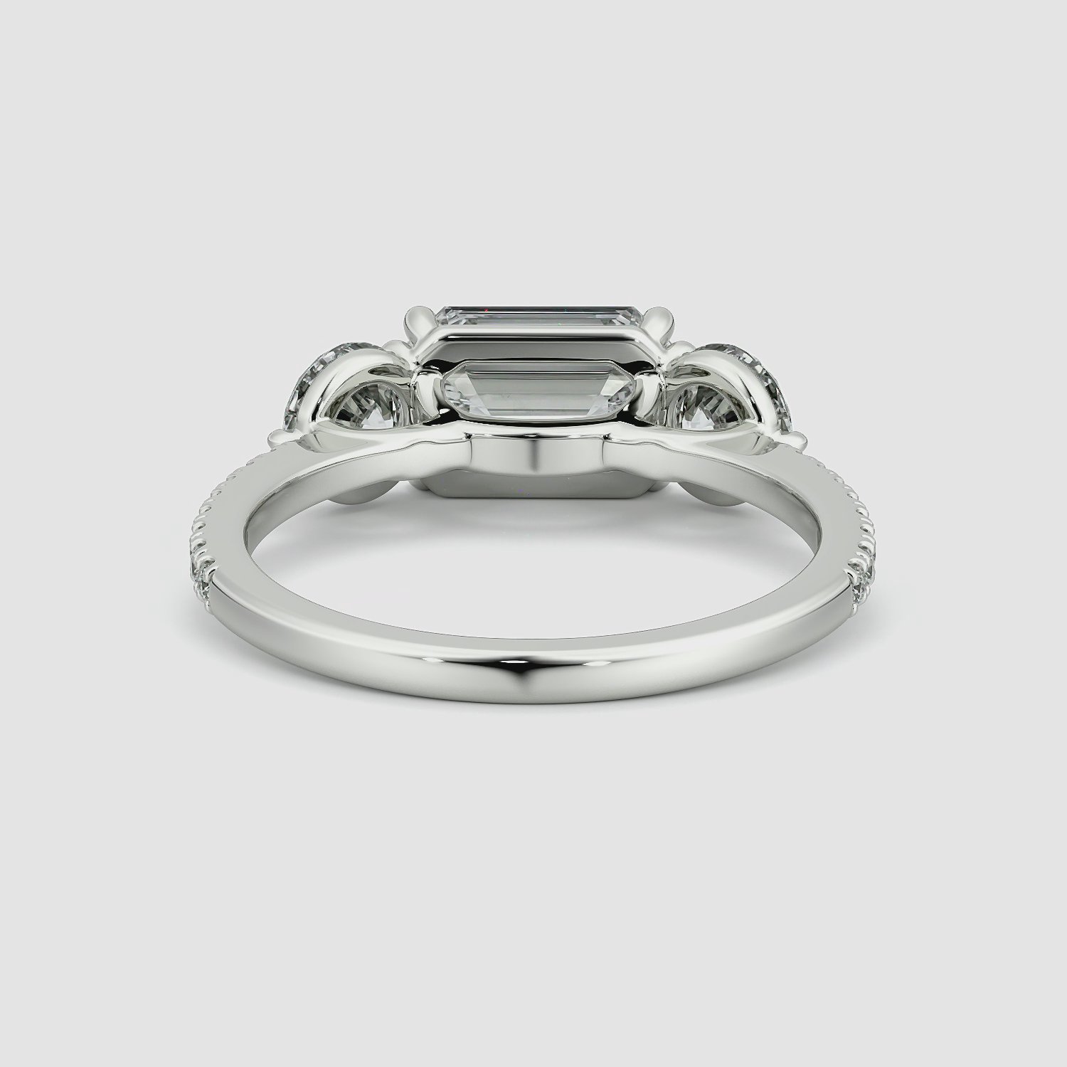 The Three Stone | Emerald | Platinum | bandAccent: Pavé | diamondOrientation: horizontal | sideStoneCarat: 0.50ct | sideStoneShape: Round Brilliant | caratWeight: other