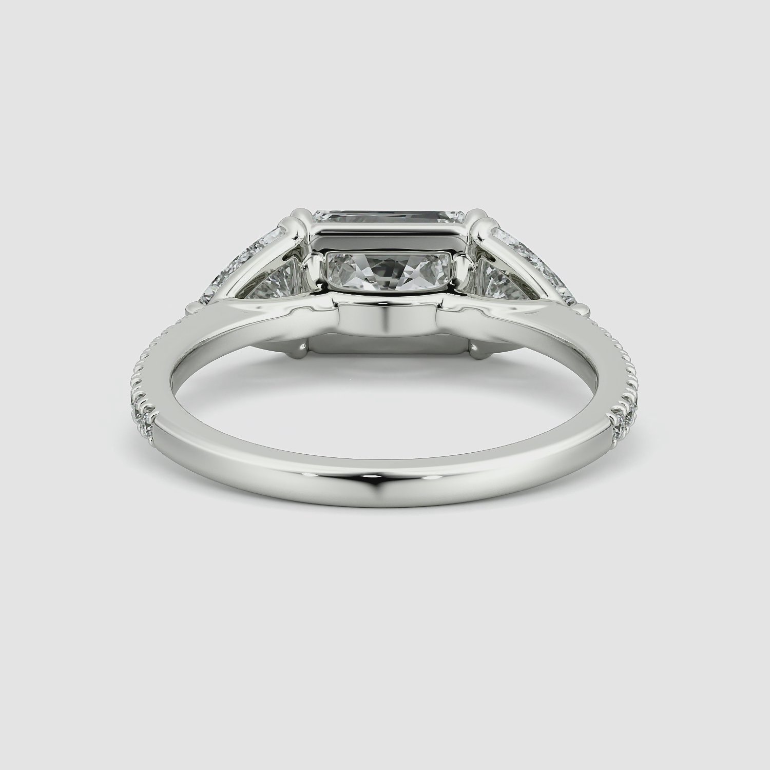 The Three Stone | Radiant | Platinum | bandAccent: Pavé | diamondOrientation: horizontal | sideStoneCarat: 0.50ct | sideStoneShape: Trillion | caratWeight: other