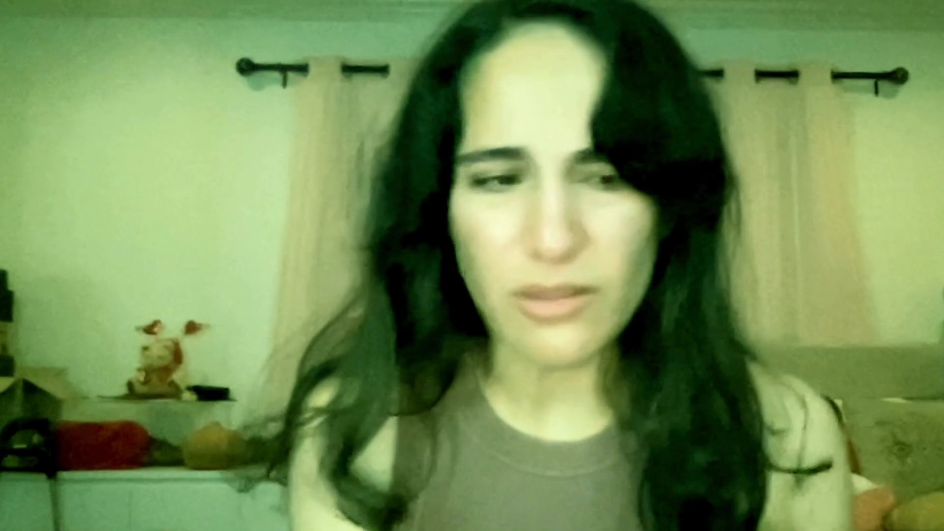 A woman expresses profound emotional distress while sharing a personal experience in a candid, conversational setting. Her facial expressions and demeanor convey a sense of vulnerability and deep reflection.