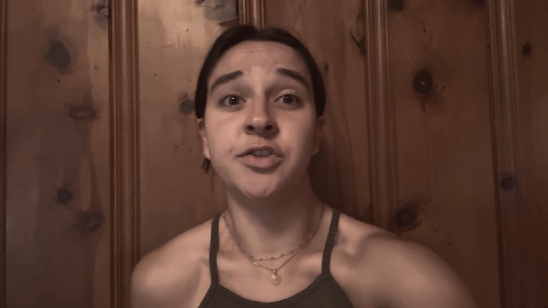 A woman speaks directly to the camera, clearly articulating her message with focused expressions and deliberate movements.