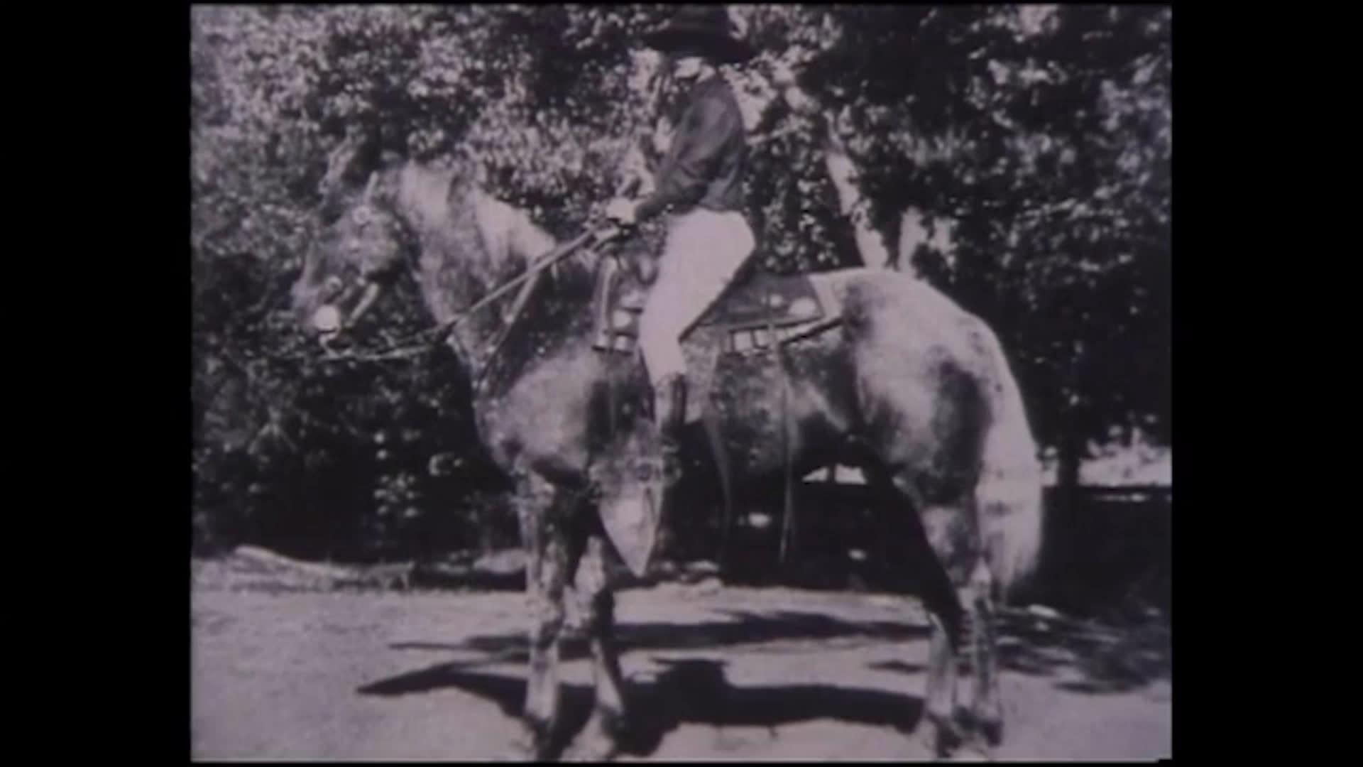 Black-and-white archival photographs follow a woman riding and racing horses at fairs and rodeos, alongside portraits and images of her mounts. The narration recalls her love of racing and reflects on her husband's death and her later loneliness as she grows older.