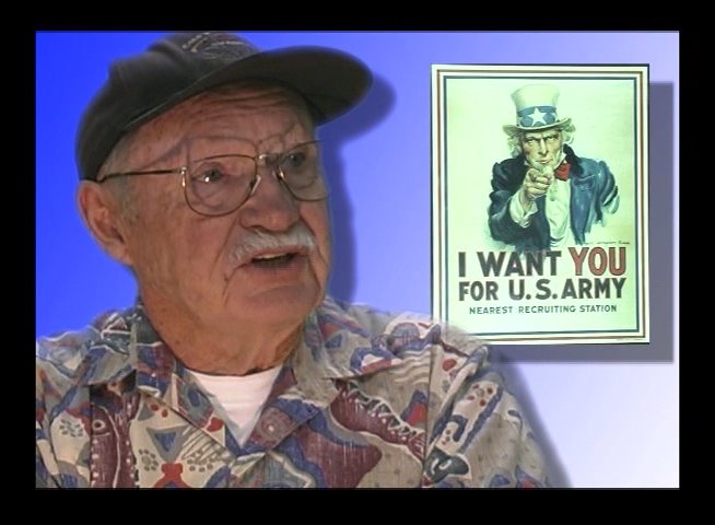 An elderly veteran discusses his wartime experiences against the backdrop of an iconic Uncle Sam recruitment poster. The interview focuses on personal memories and historical context related to military service.