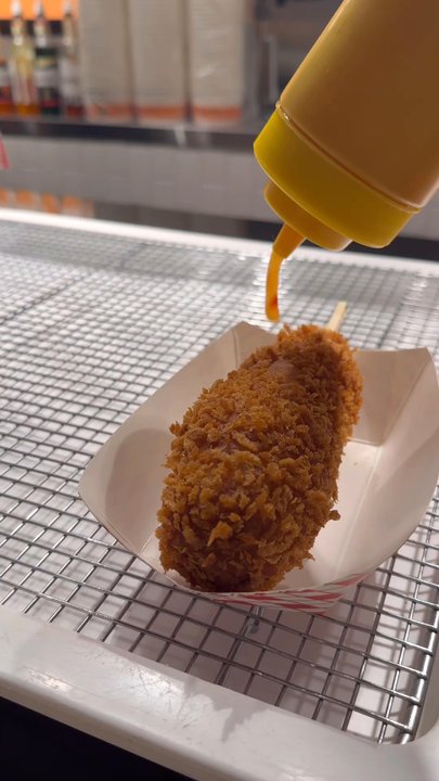 Oh K-Dog - Adding toppings to a cheddar hot dog - Hot Dogs Near Me - Arlington, Virginia