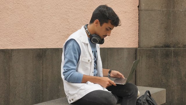 Man using his laptop outdoors