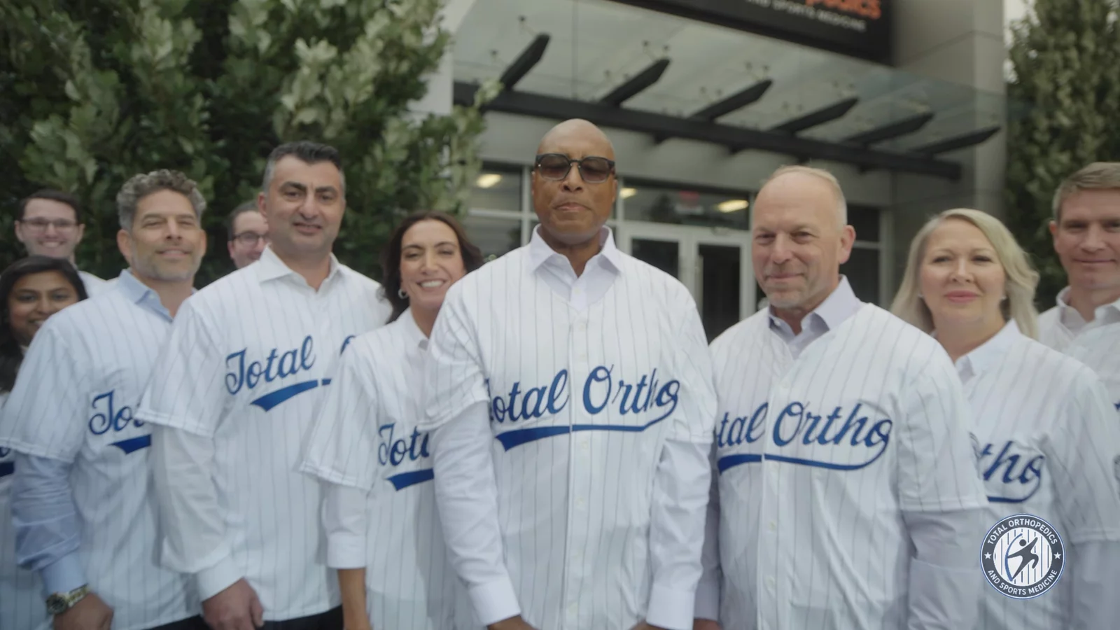 Bernie Williams with the Total Ortho team in team jerseys