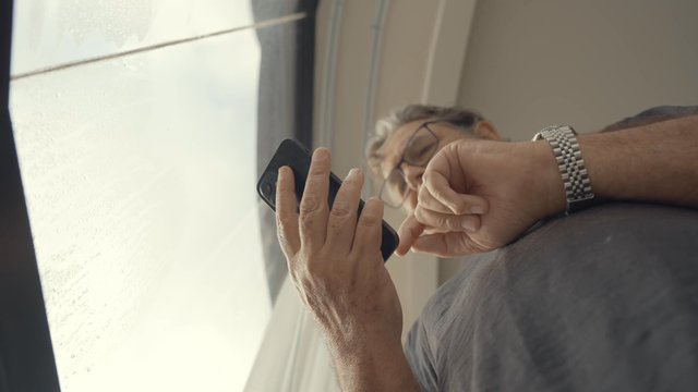 A man carefully using his smartphone 