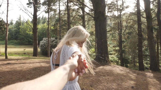 Holding hands in the forest