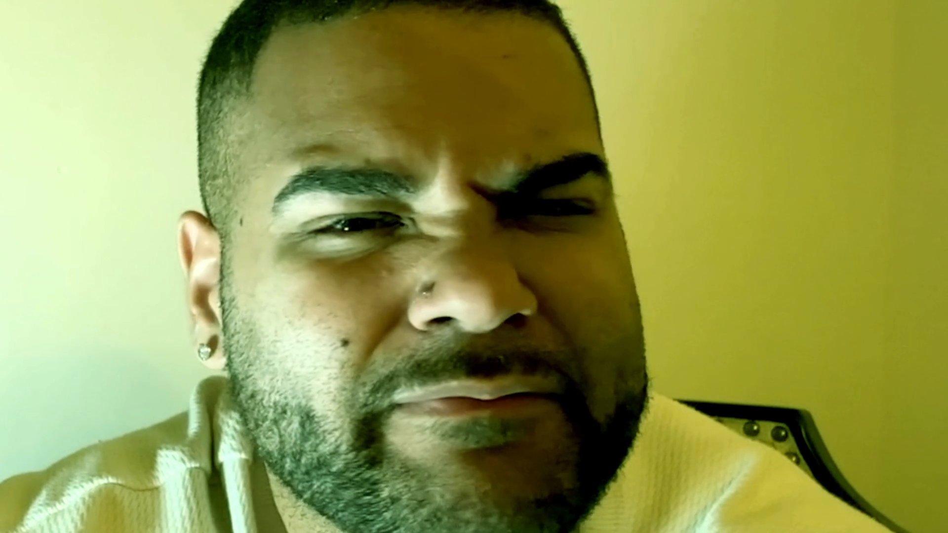 A man shares a personal narrative while directly addressing the camera, using expressive gestures to emphasize his points. His demeanor conveys a blend of introspection and sincere engagement with the subject matter.