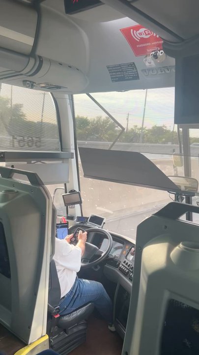 RedCoach - Bus driver FaceTiming friends while driving with one hand on the wheel, swerving in and out of lanes. - Public Transportation Near Me - Miami, Florida