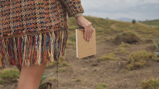 Woman holding a notebook and pen