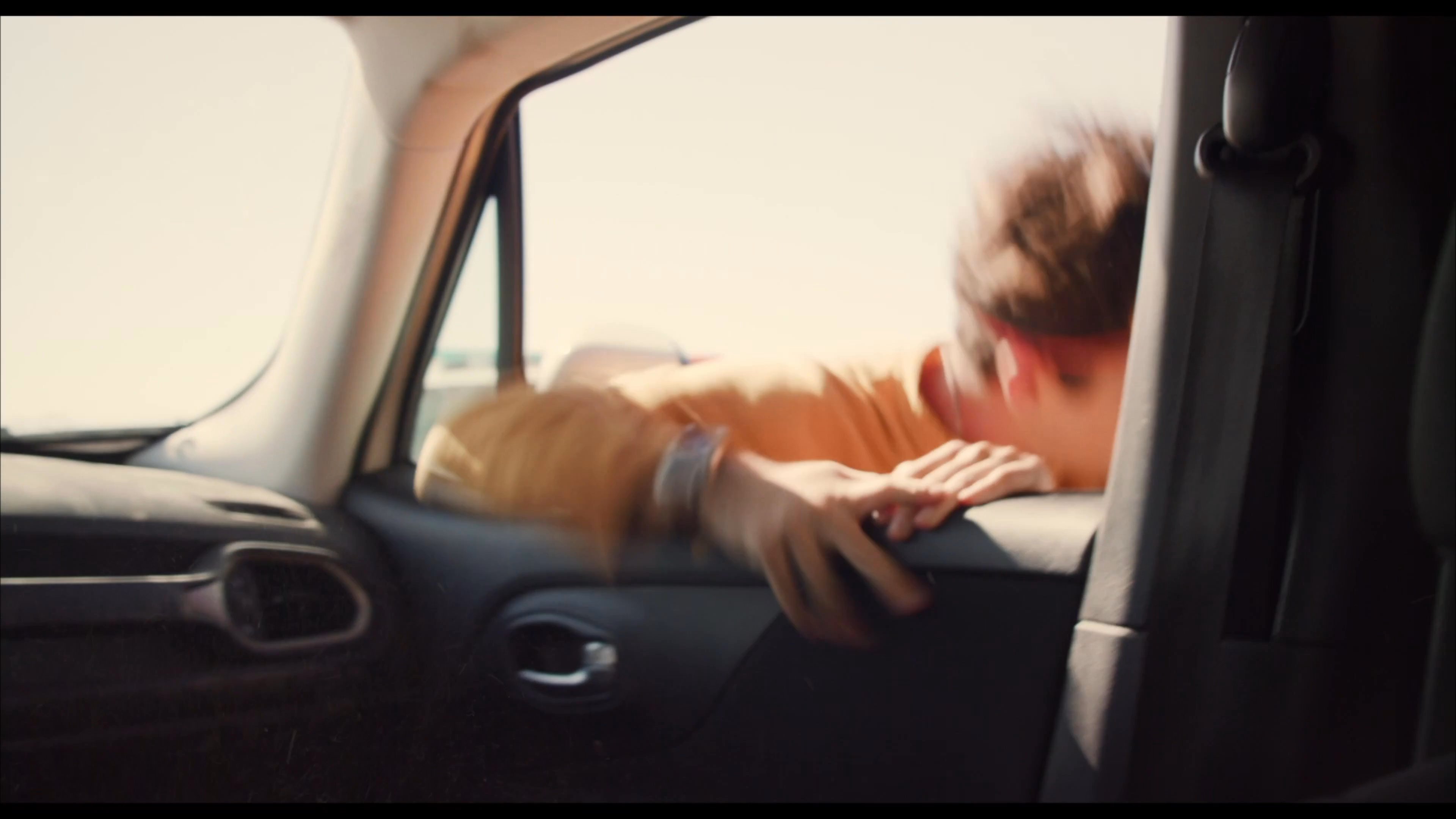 A law enforcement officer in a desert setting apprehends and handcuffs a suspect near a vehicle during a stop. The sequence shows the escalation from a roadside confrontation to the physical detention of the individual.