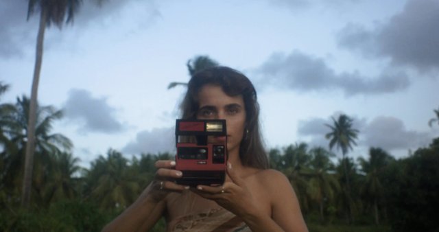 A photographer using a Polaroid camera