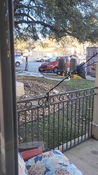 Rocking Horse Ranch - Workers blowing extra insulation from outside my patio - Apartments Near Me - Round Rock, Texas