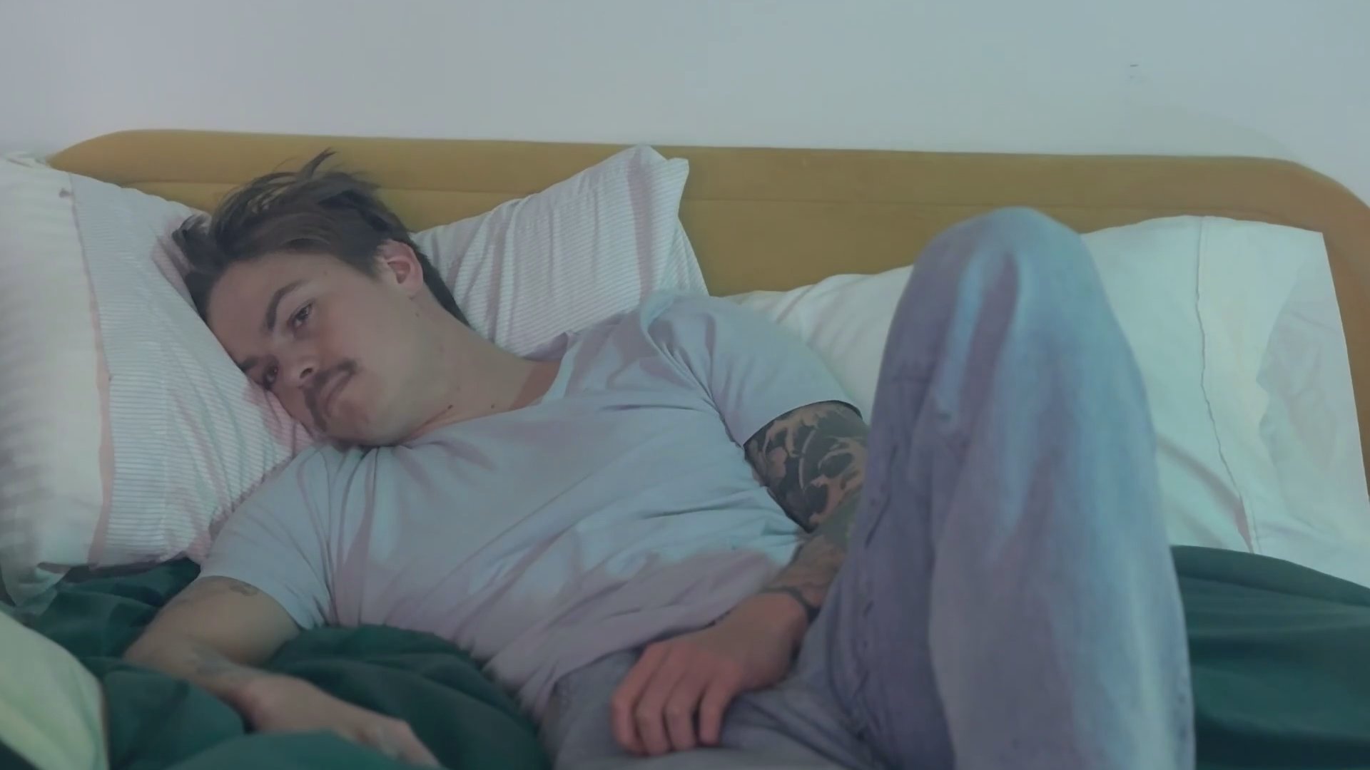 A documentary-style segment examines a rising statistical trend of male virginity among those under thirty, juxtaposing broadcast television discussions with intimate, solitary personal reflection.