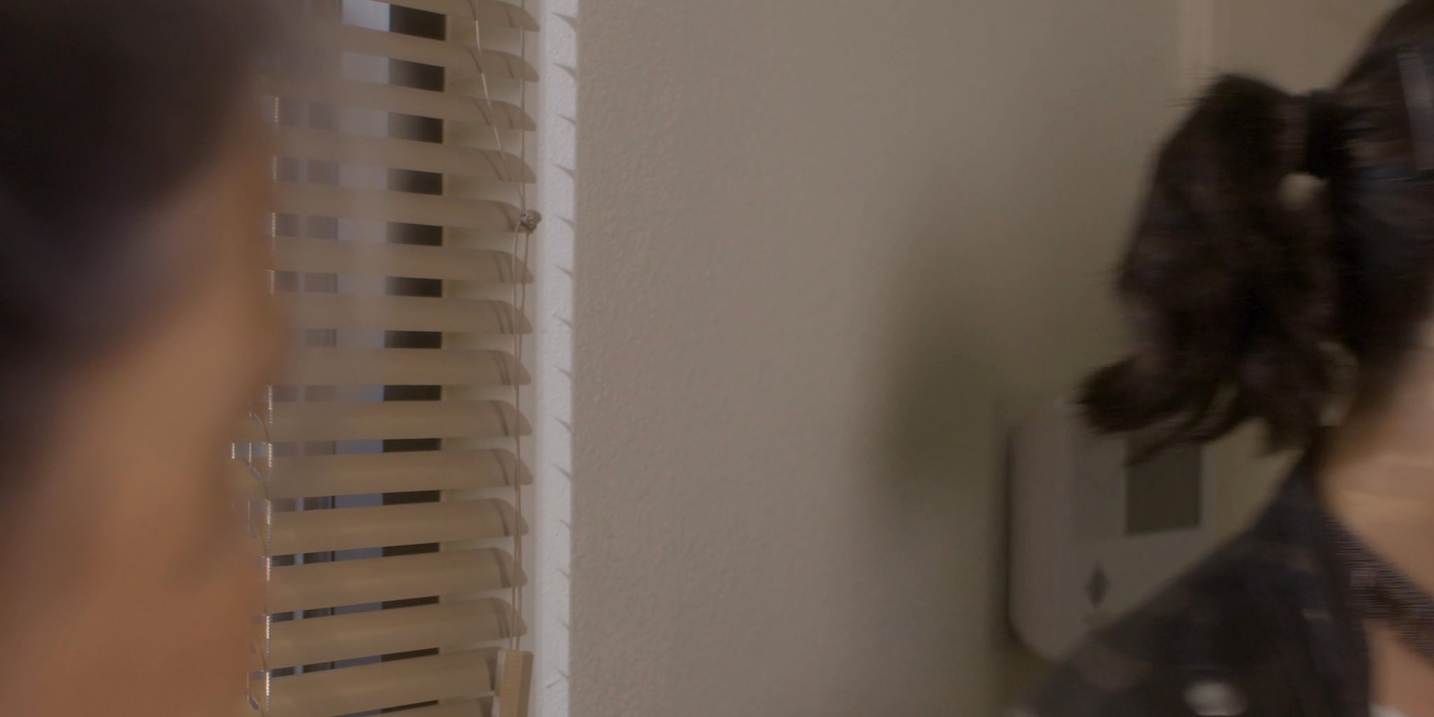 An older woman and a younger woman engage in a sincere conversation in a home setting. The exchange highlights a quiet, personal moment between family members.