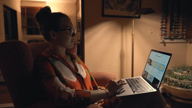 A girl explores NFT collections on the OpenSea website