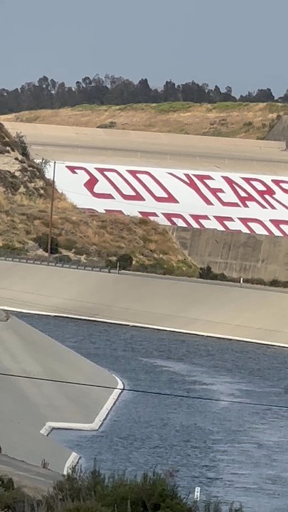 The Prada Dam Bicentennial Mural - The Prada Bicentennial Mural is 106 ft tall, 2,280 ft wide with The Liberty Bell & reads 200 Years of Freedom 1776-1976 in red white & blue - Landmarks & Historical Buildings Near Me - Corona, California
