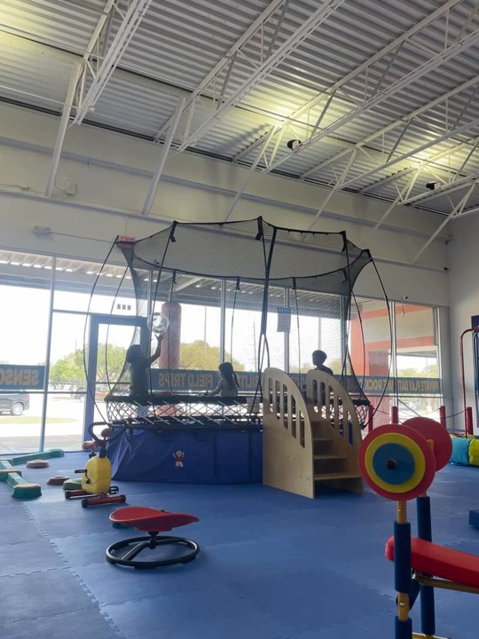 We Rock The Spectrum - View of the gym & a little soft dodgeball in the trampoline. - Indoor Playcenter Near Me - Austin, Texas