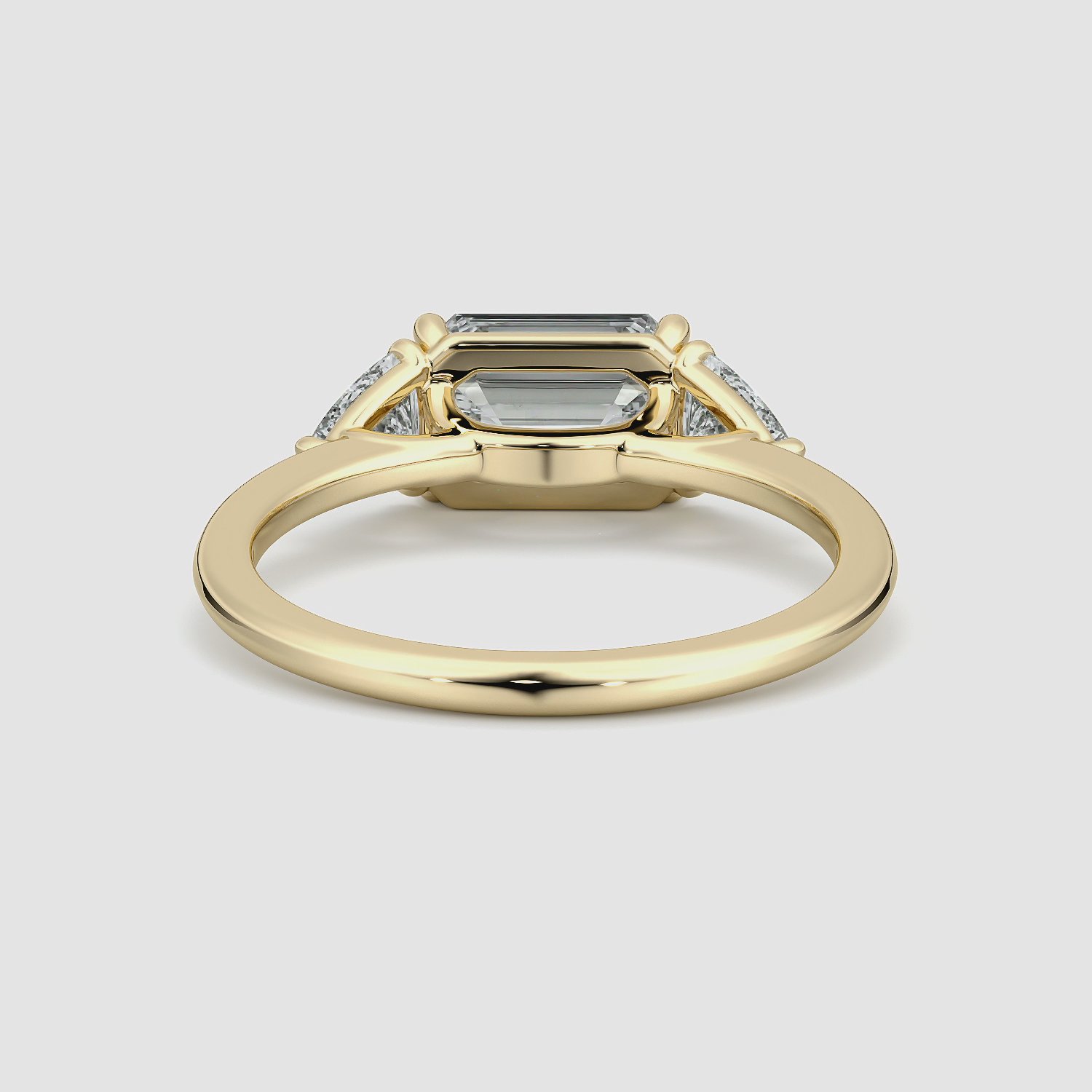 The Three Stone | Emerald | 18k | Yellow Gold | bandAccent: Plain | diamondOrientation: horizontal | sideStoneCarat: 0.25ct | sideStoneShape: Trillion | caratWeight: other