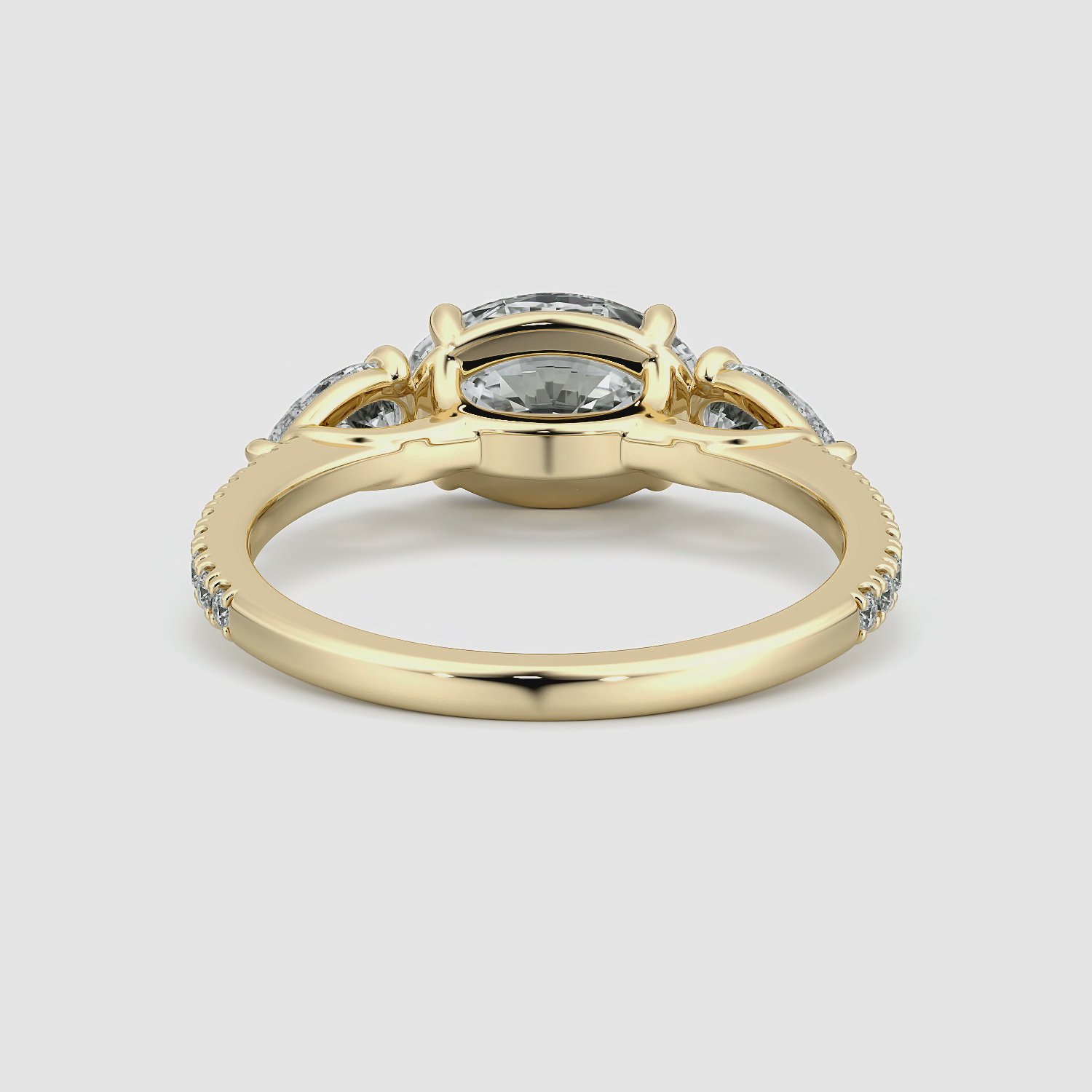 The Three Stone | Oval | 18k | Yellow Gold | bandAccent: Pavé | diamondOrientation: horizontal | sideStoneCarat: 0.25ct | sideStoneShape: Pear | caratWeight: other