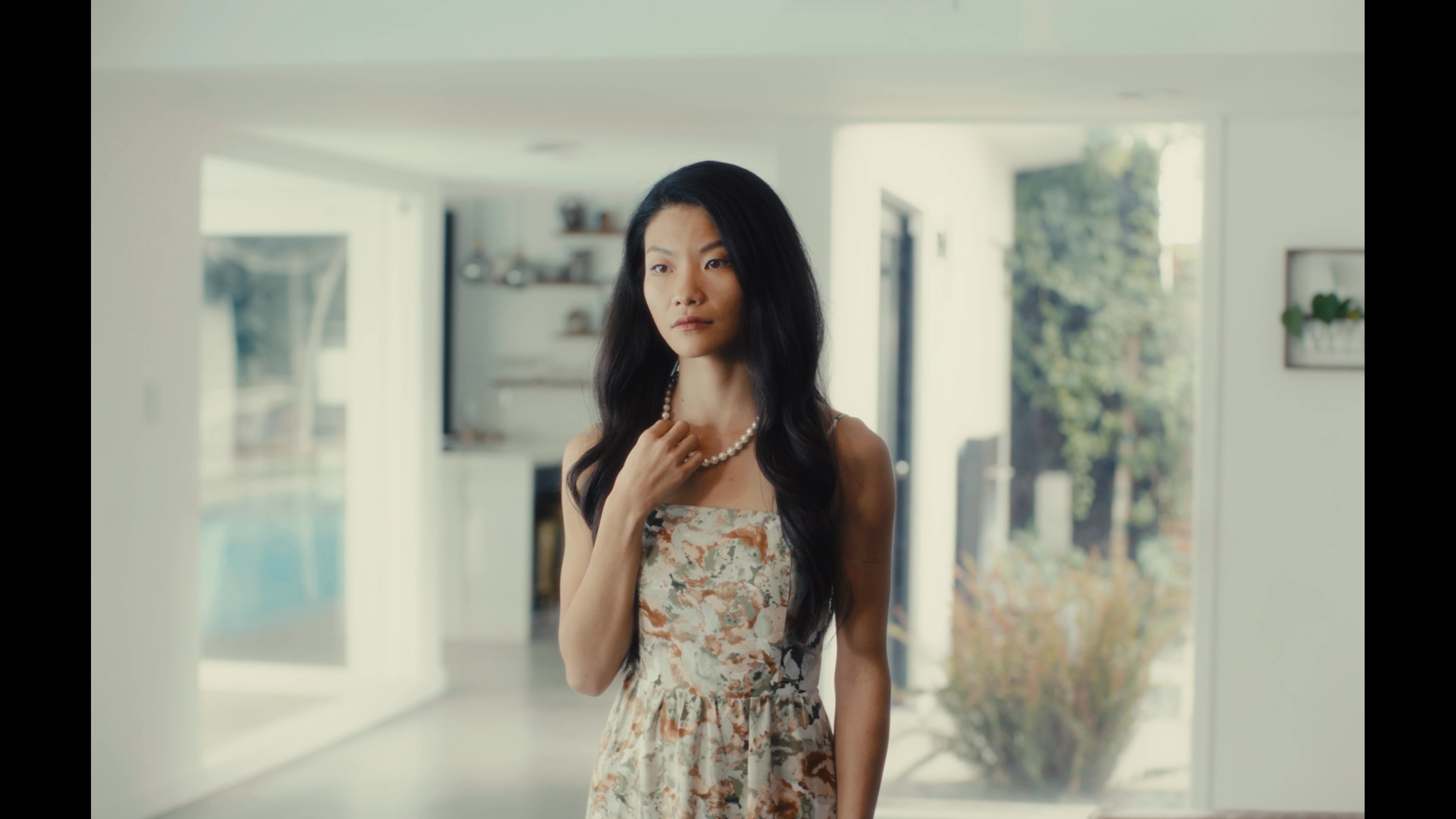 A man wearing a virtual reality headset interacts with an AI digital assistant, which manifests as a voice interface within his living environment.