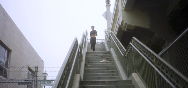 Woman running down outdoor steps