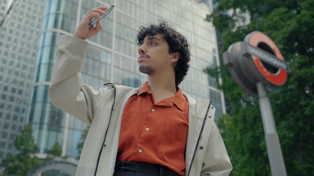 A young man using his phone in the city