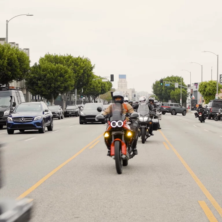 Motorcyclists in the middle of Los Angeles street riding by