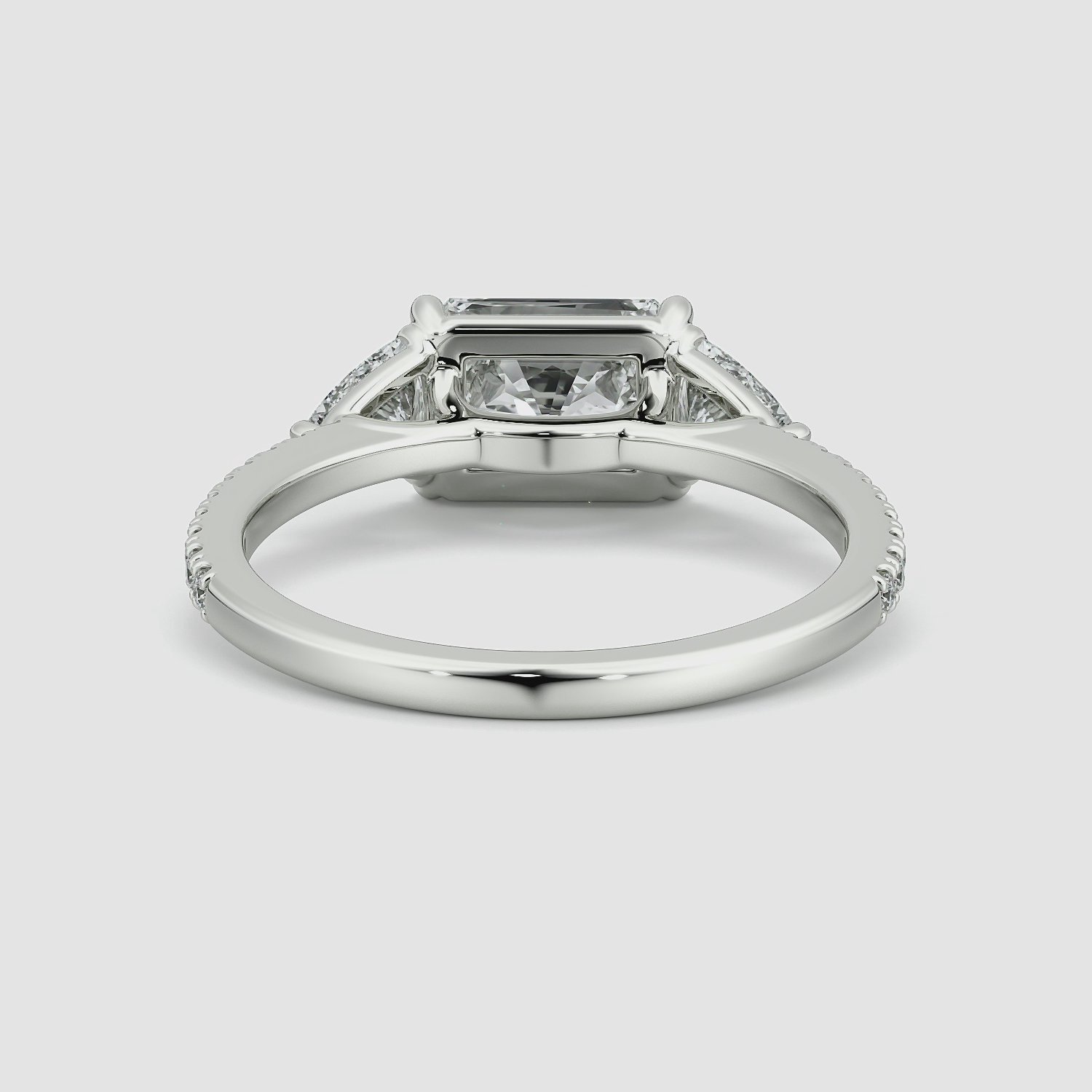 The Three Stone | Radiant | Platinum | bandAccent: Pavé | diamondOrientation: horizontal | sideStoneCarat: 0.25ct | sideStoneShape: Trillion | caratWeight: other