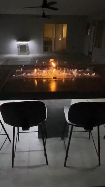 Fire pit bar table with concrete top, built-in fire glass, under-glow lighting & seating