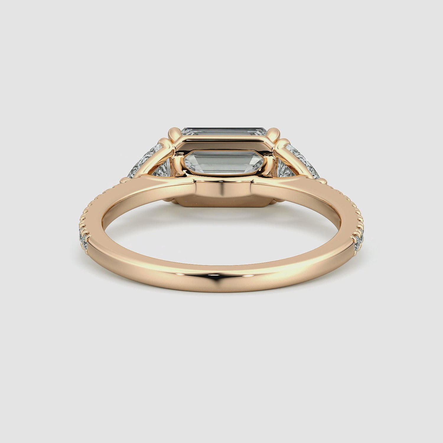 The Three Stone | Emerald | 14k | Rose Gold | bandAccent: Pavé | diamondOrientation: horizontal | sideStoneCarat: 0.25ct | sideStoneShape: Trillion | caratWeight: other