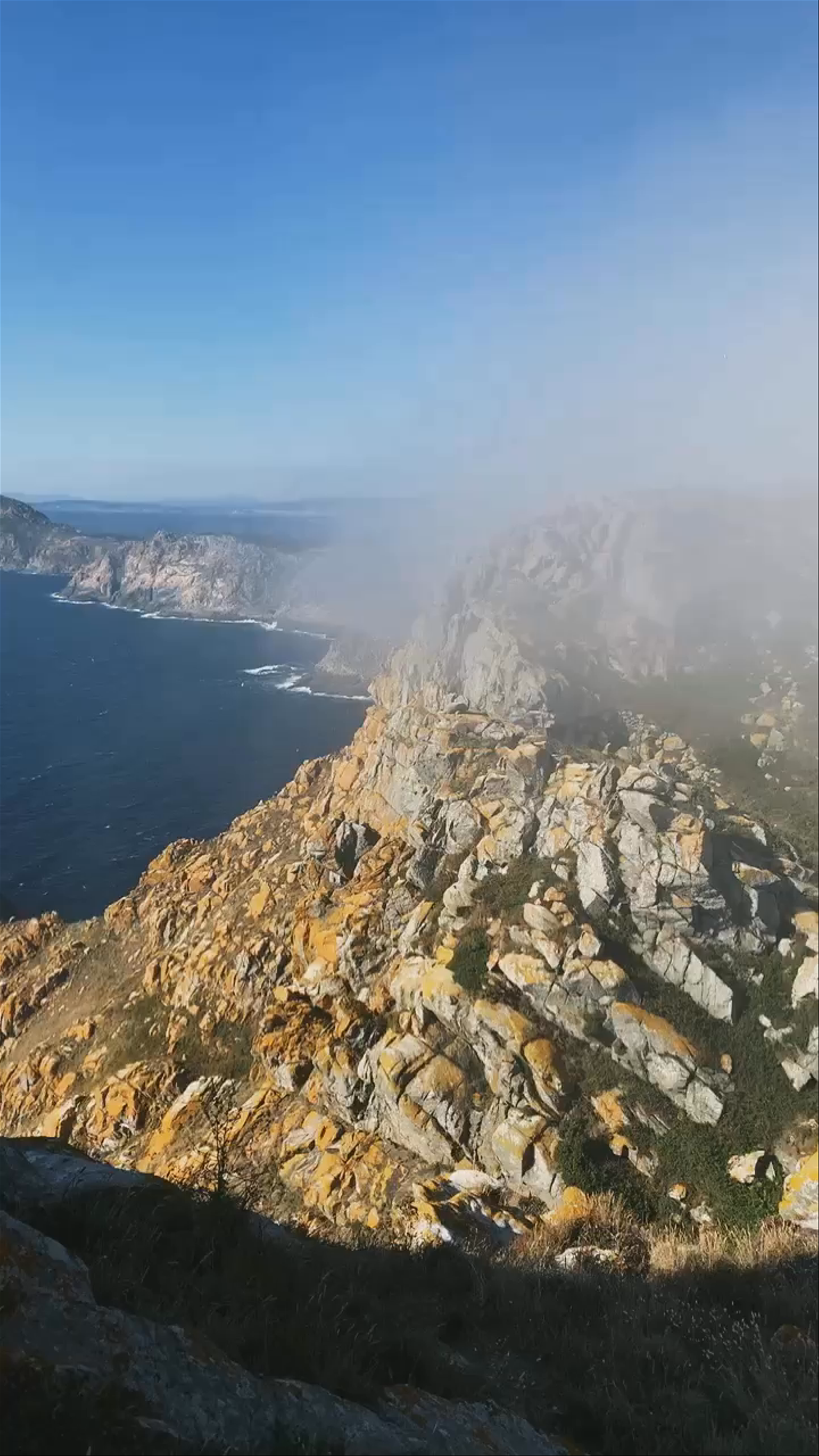 Dramatic Coastal Cliffs and Mist at Faro de Cíes, Spain