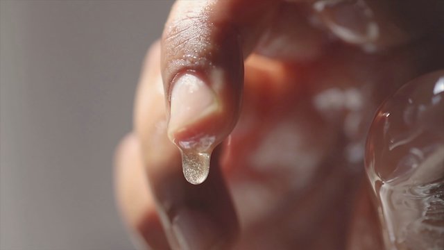 Honey dripping from a finger