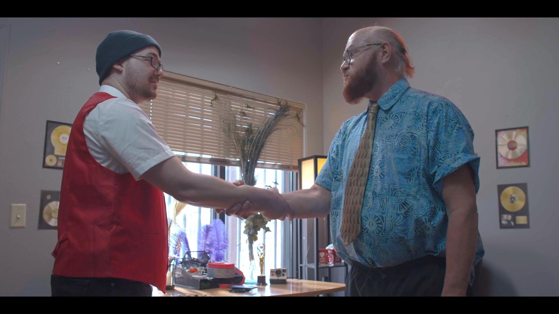 Two individuals finalize a professional agreement with a handshake after a deliberate discussion in an office environment.