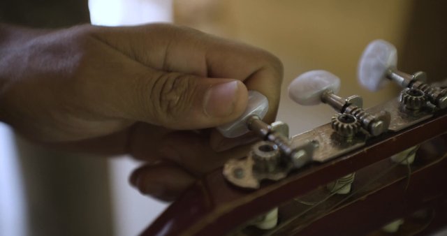 Hand-tuning a guitar