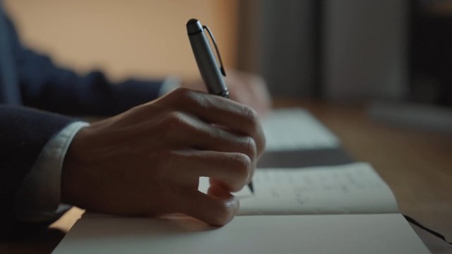 A trader writing something in a notebook