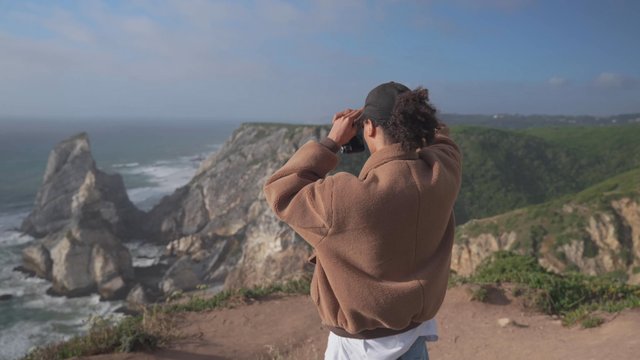 A guy takes photos of a seascape