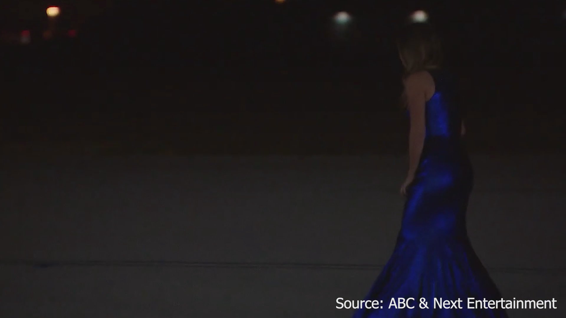A bachelor performs an elimination ceremony before a contestant experiences intense emotional distress, ultimately collapsing in tears on a landing strip.