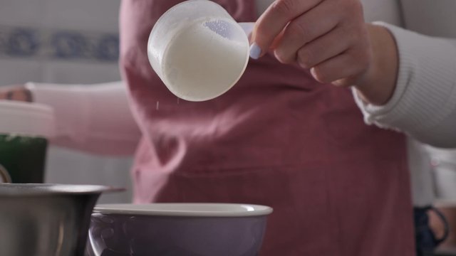 Pouring sugar in a bowl