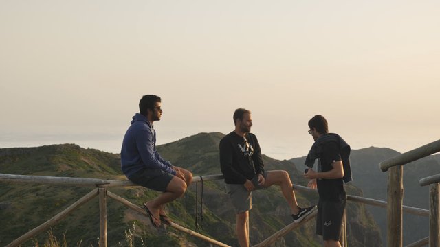 Men hanging out on mountain top