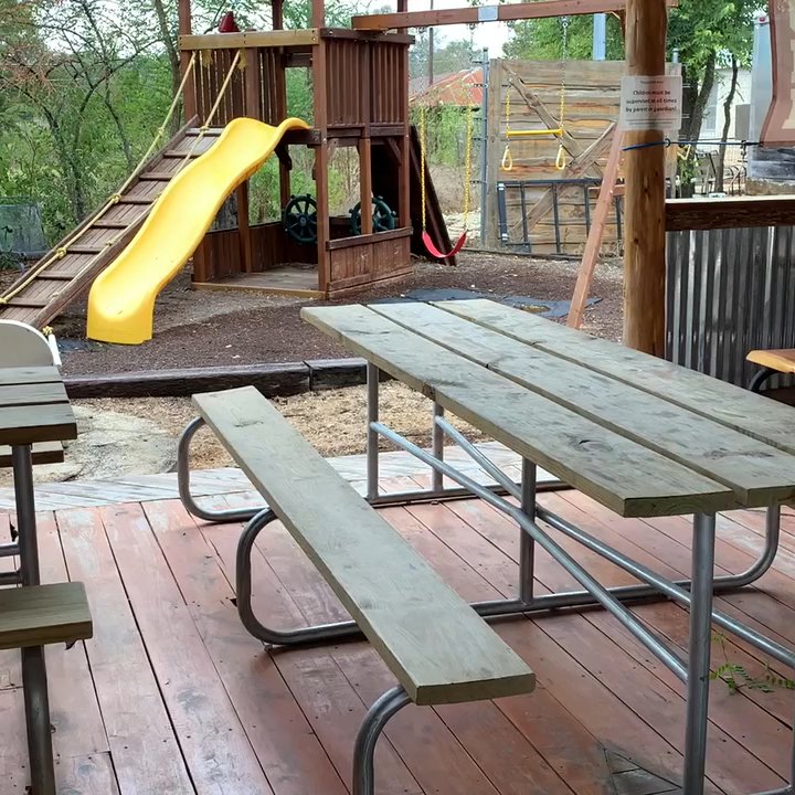Pig Pen BBQ - Standing in covered picnic area looking at the food truck. - Barbeque Near Me - Dripping Springs, Texas