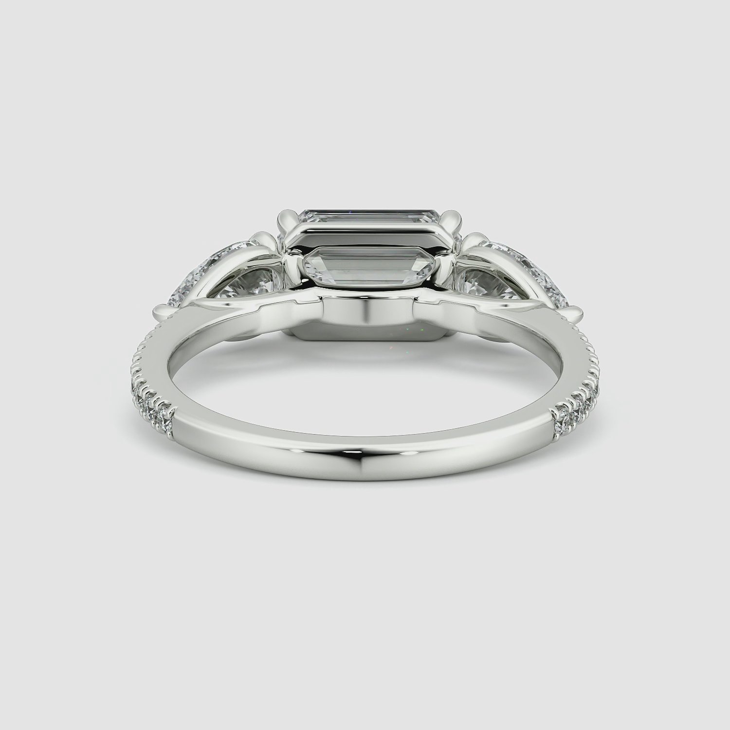 The Three Stone | Emerald | Platinum | bandAccent: Pavé | diamondOrientation: horizontal | sideStoneCarat: 0.50ct | sideStoneShape: Pear | caratWeight: other