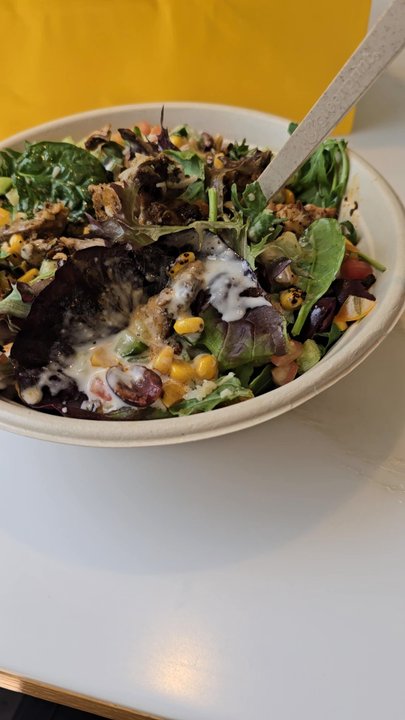 CAVA - Build a bowl chicken, spring greens, arugula, corn and cucumber. The dressing is your choice! - Mediterranean Near Me - Azusa, California