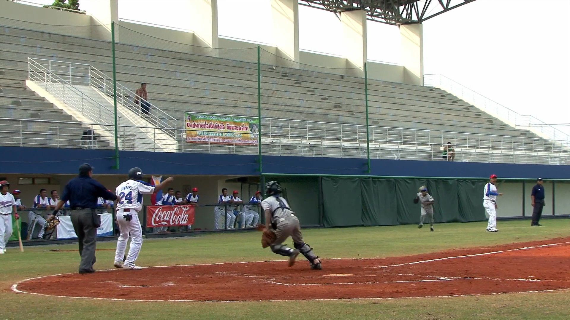 Players compete on a baseball field during a match between the Philippines and Cambodia, leading to a final score of 12-0.