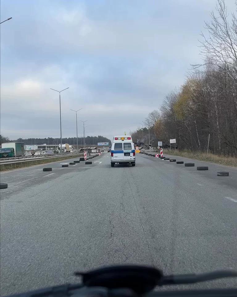 POV video of caravan of volunteer trucks driving down Ukranian highway