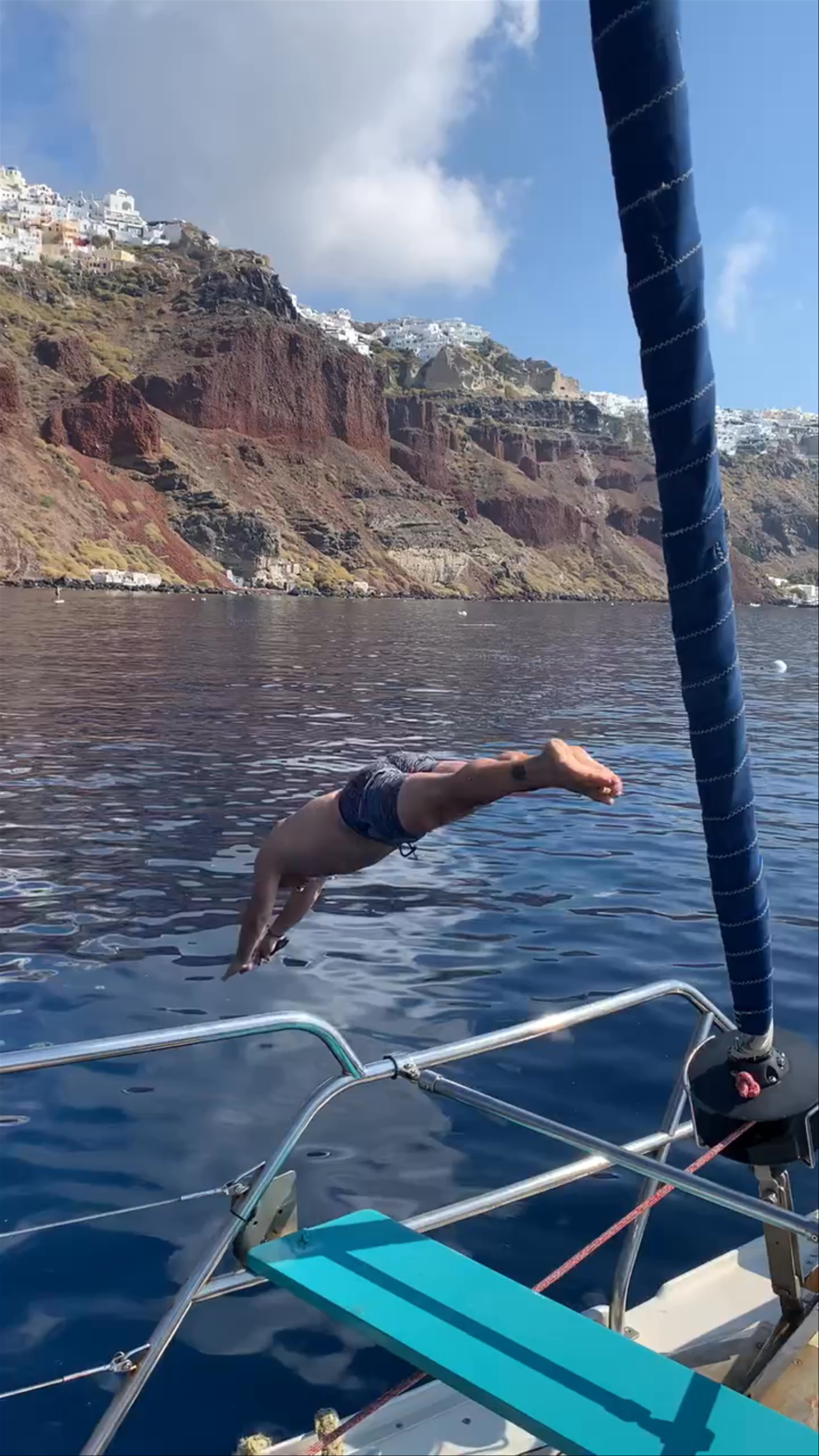 Diving into Santorini's Caldera from a Sailing Boat