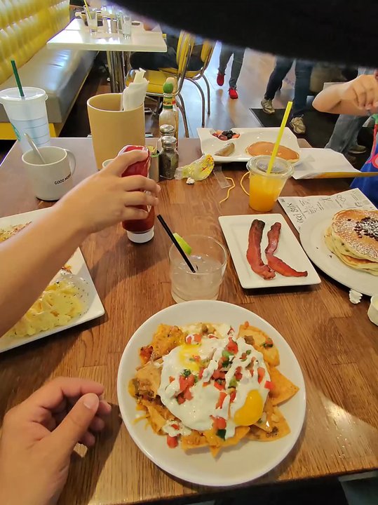 Over Easy - Surprise - First person view of table and chilaquiles - Breakfast & Brunch Near Me - Surprise, Arizona